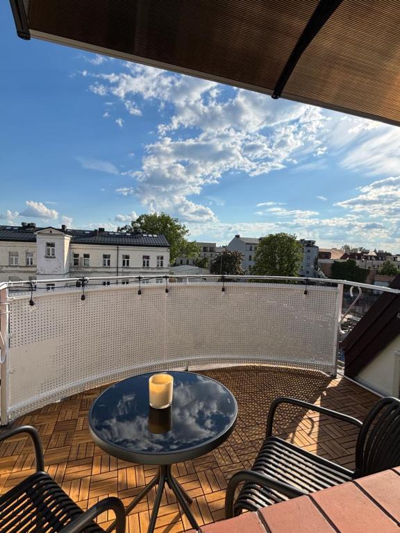 a patio with a table and chairs on a balcony at Apartament Królewiecka in Płock