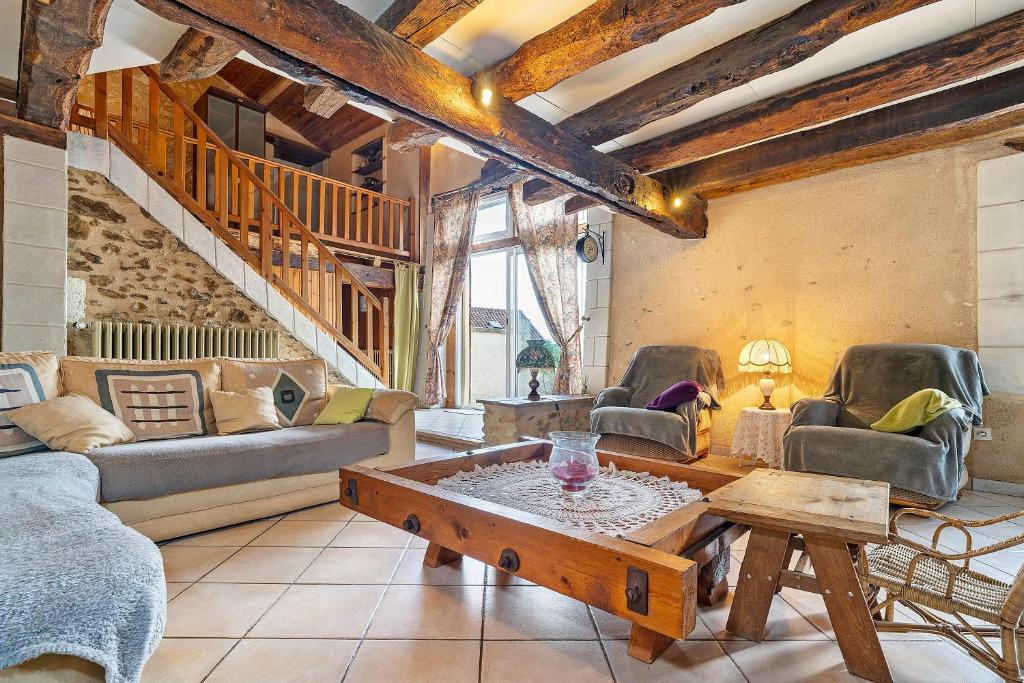 a living room with a couch and a table at Le Séchoir D'Alice in Saint-Germain-du-Salembre