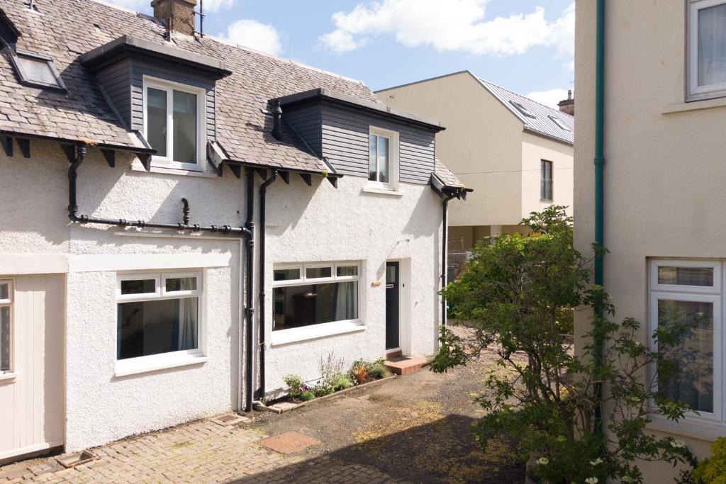 a white house with a black roof at Willow Cottage, North Street in St. Andrews