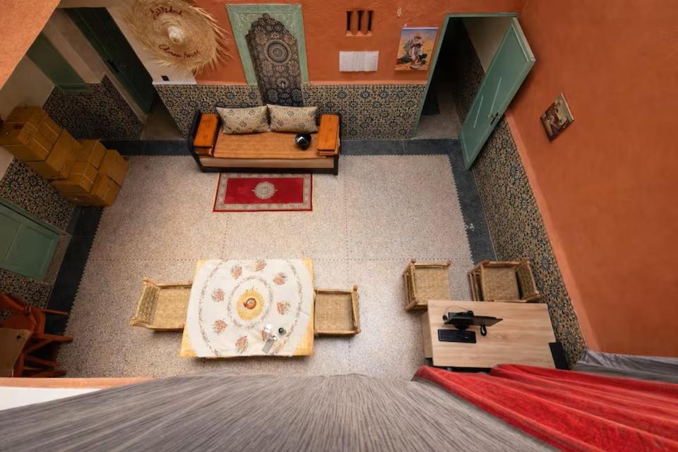 an overhead view of a living room with a couch and tables at Palm Hostel in Marrakesh