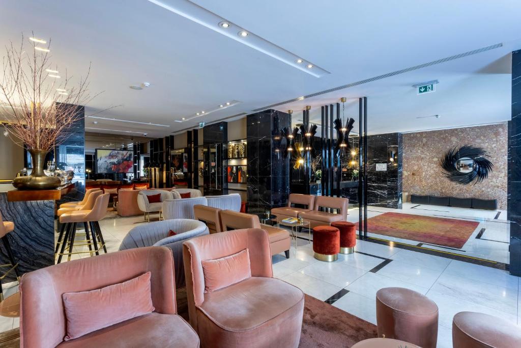 A spacious contemporary lobby with plush seating, a reception area and marble finishes.