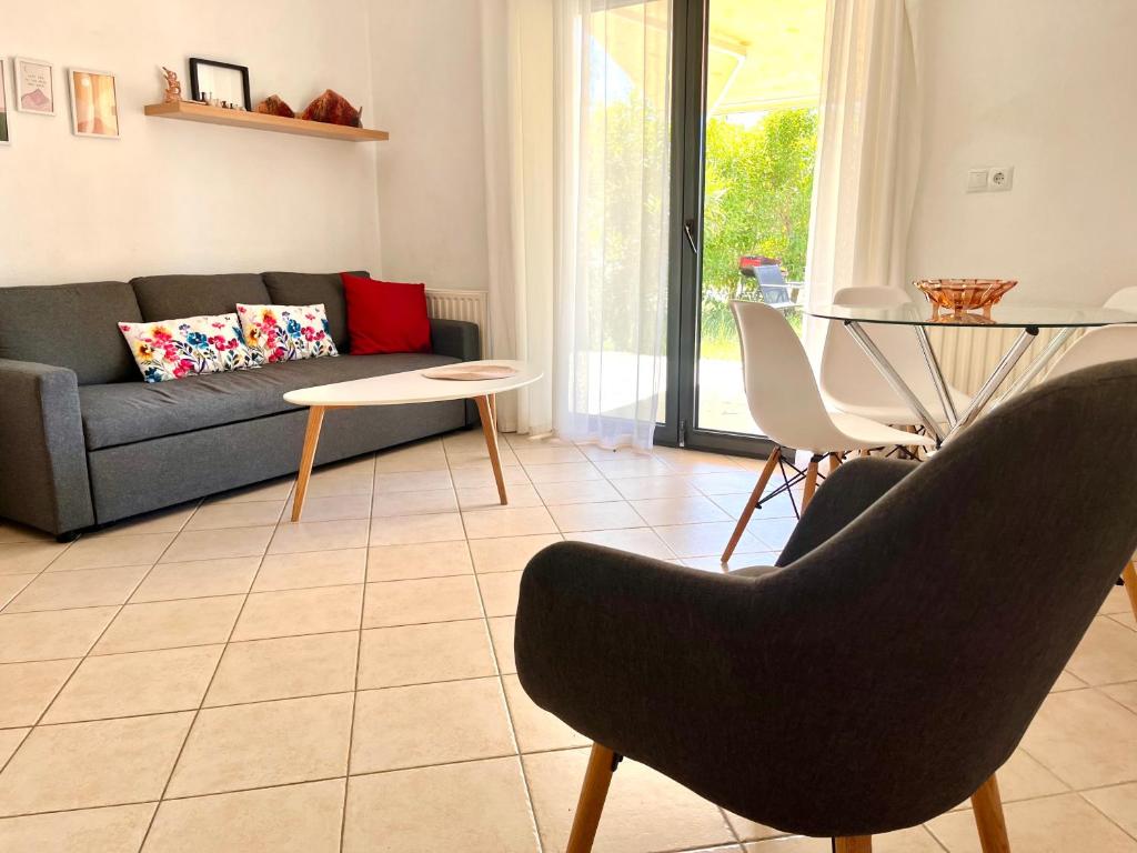 a living room with a couch and chairs and a table at SUNNY 2, Two-bedroom house with parking in Komotini