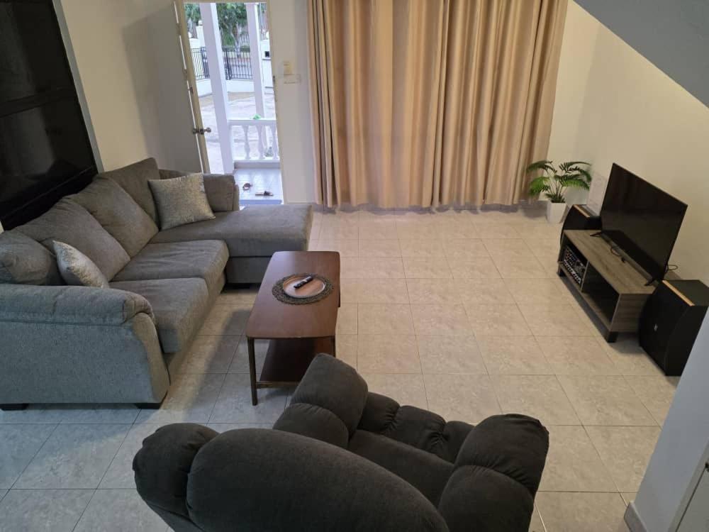 a living room with a couch and a table at Osvy Palm Homestay in Penampang