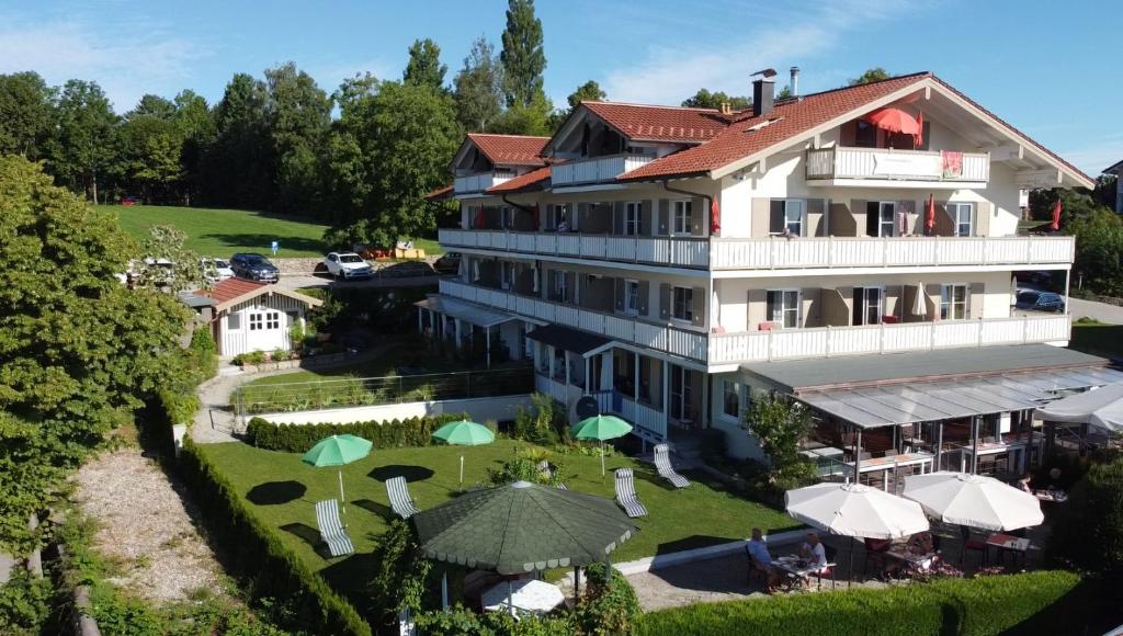 an aerial view of a building with umbrellas at ChiemseeStern Vacation & Recreation Adults Only in Gstadt am Chiemsee