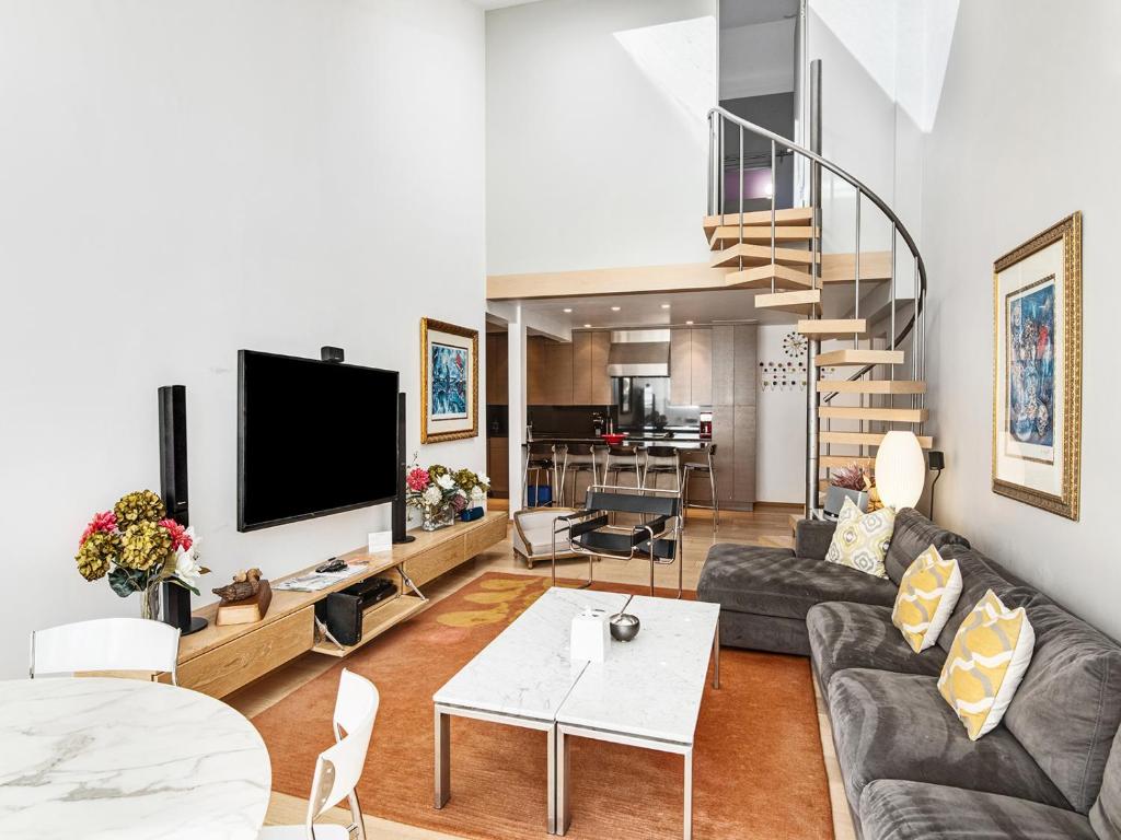 a living room with a couch and a tv at Lionshead Center in Vail