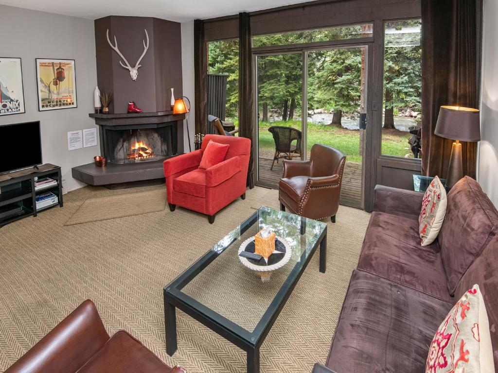 a living room with a couch and chairs and a fireplace at Ptarmigan Townhome 2 in Vail