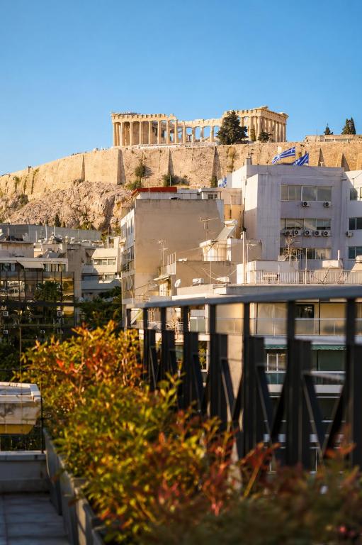 a view of buildings with the acropolis in the background at Tyto Alba Habitat in Athens
