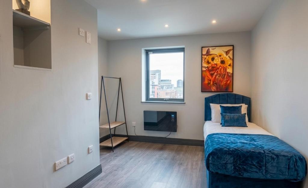 a bedroom with a bed and a large window at Spacious one bedroom flat- super fast Wifi - slp4 -SHIP02 in Brighton & Hove
