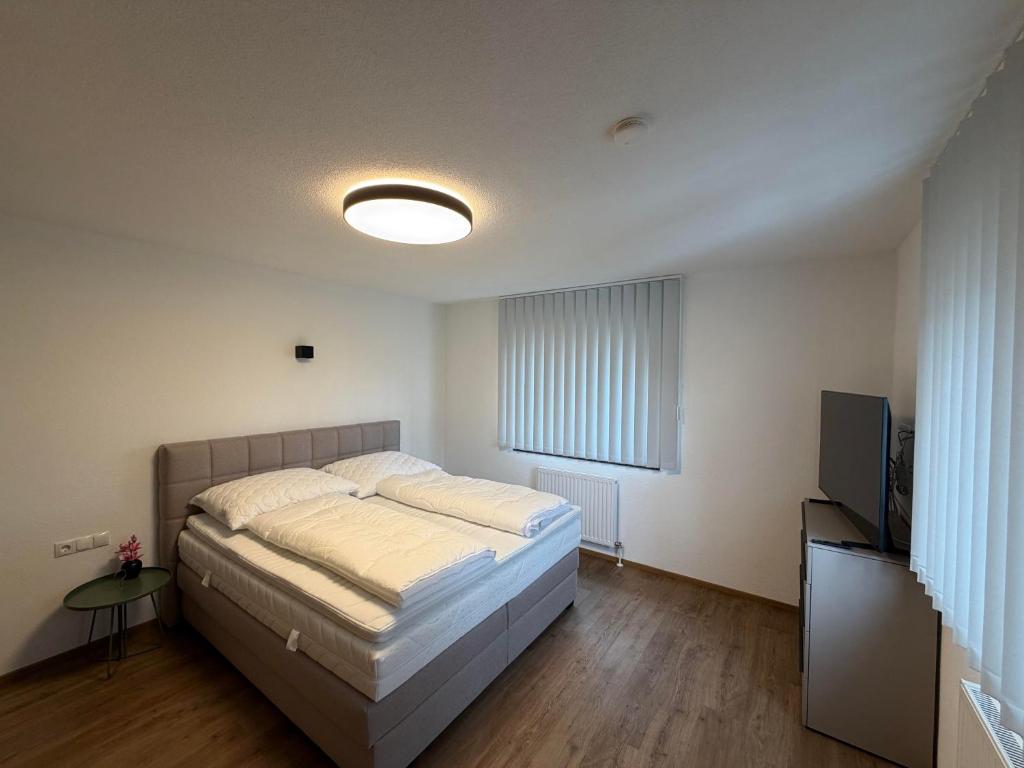 a bedroom with a bed and a flat screen tv at Mountain hOMES in Axams