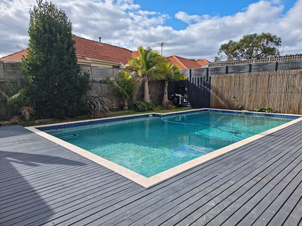 a swimming pool on top of a wooden deck at Seffa 5 vella property in Springvale South