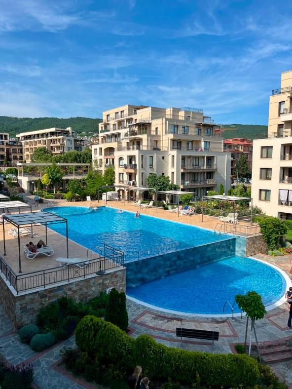 a large swimming pool in front of some buildings at Sorrento Pool View Apartment in Sveti Vlas