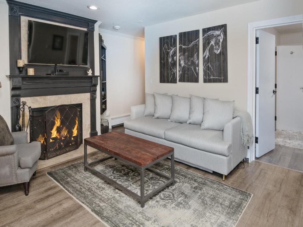a living room with a couch and a fireplace at Vail 21 Condo 502 in Vail