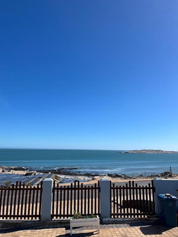 a view of the beach from a wooden fence at Sunrise Villa Self Catering and Accommodation in Lüderitz