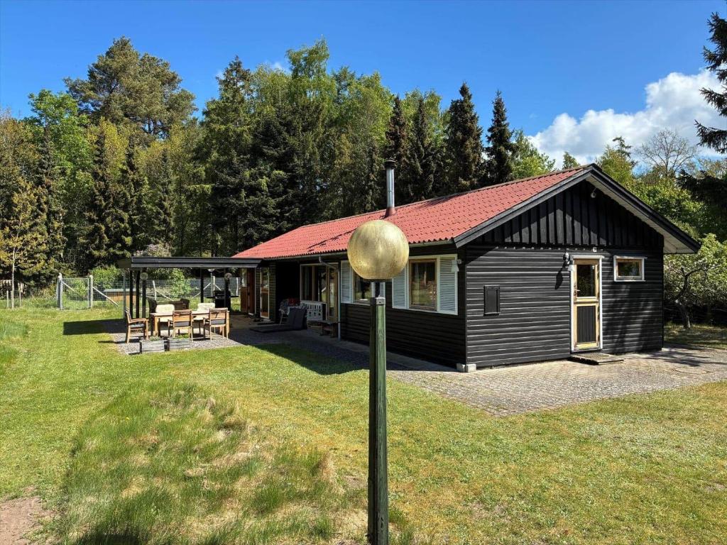 a small cabin with a red roof on a field at FJ2002-Skibby-Stormgardsvej-11 in Skibby