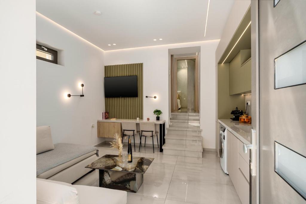 a living room with a couch and a table at The Luxe Residence in episkopi-chania