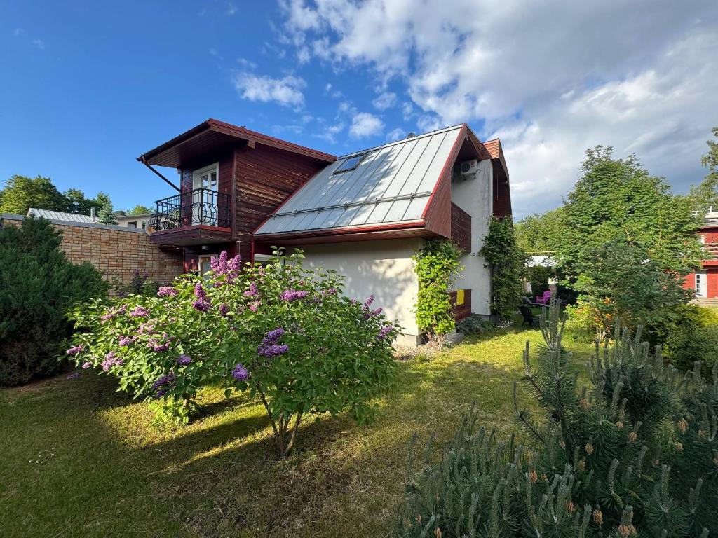 a house with a solar panel on the roof at Melluzi Seaside Residence in Jūrmala