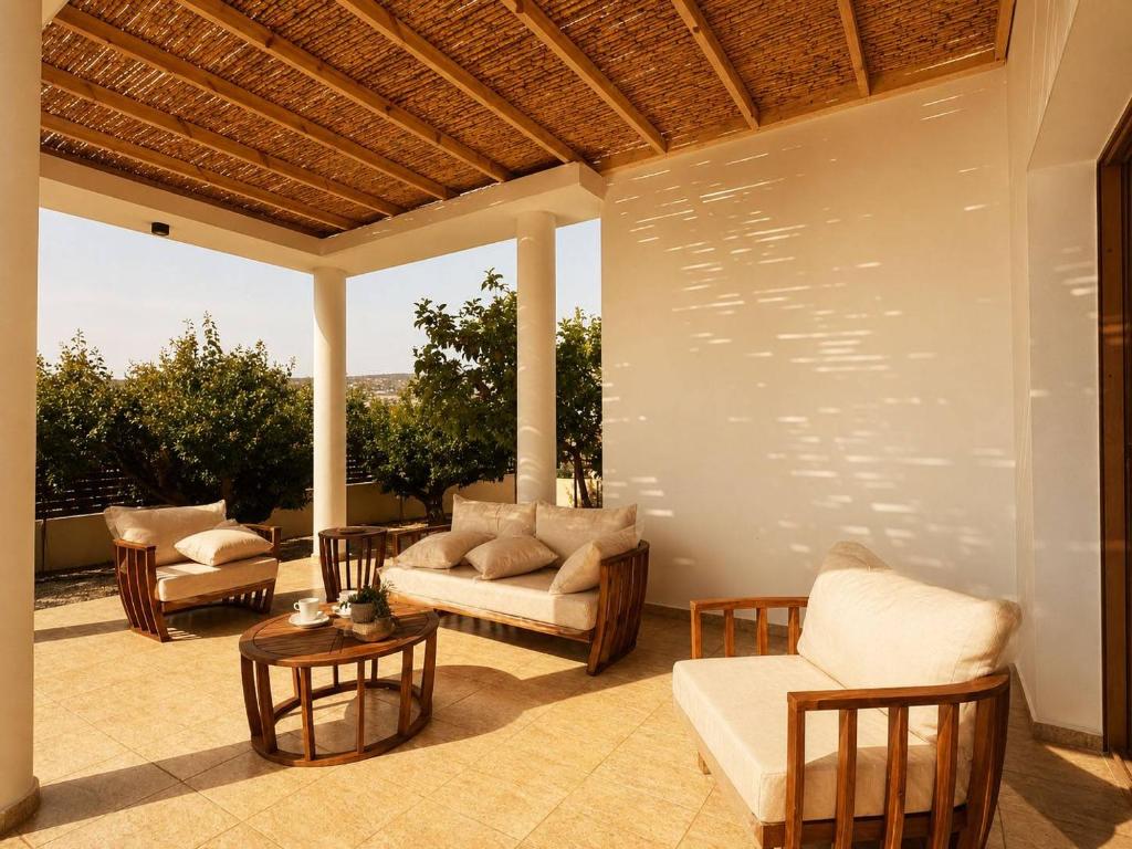 a patio with couches and chairs and a table at Mariandy Villa 2 in Coral Bay