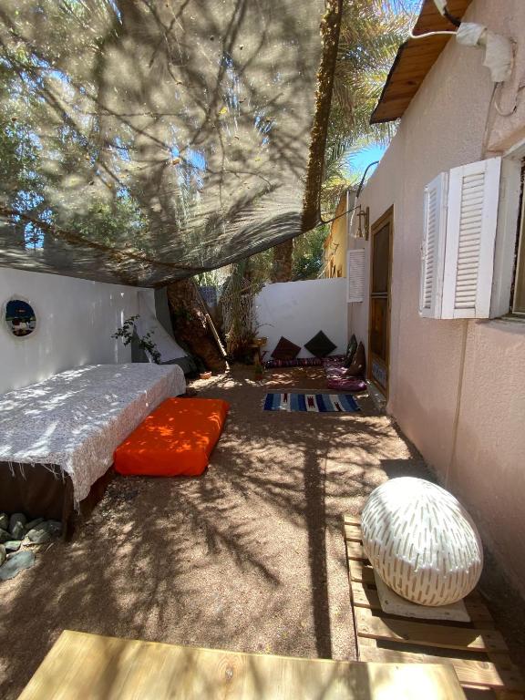 a bedroom with a bed and a tree at Bedro Private Garden Studio & Outdoor Lounge 1 Min to Sea in Dahab