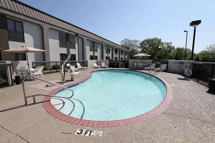 a large swimming pool in front of a building at Dyersburg Hotel in Dyersburg