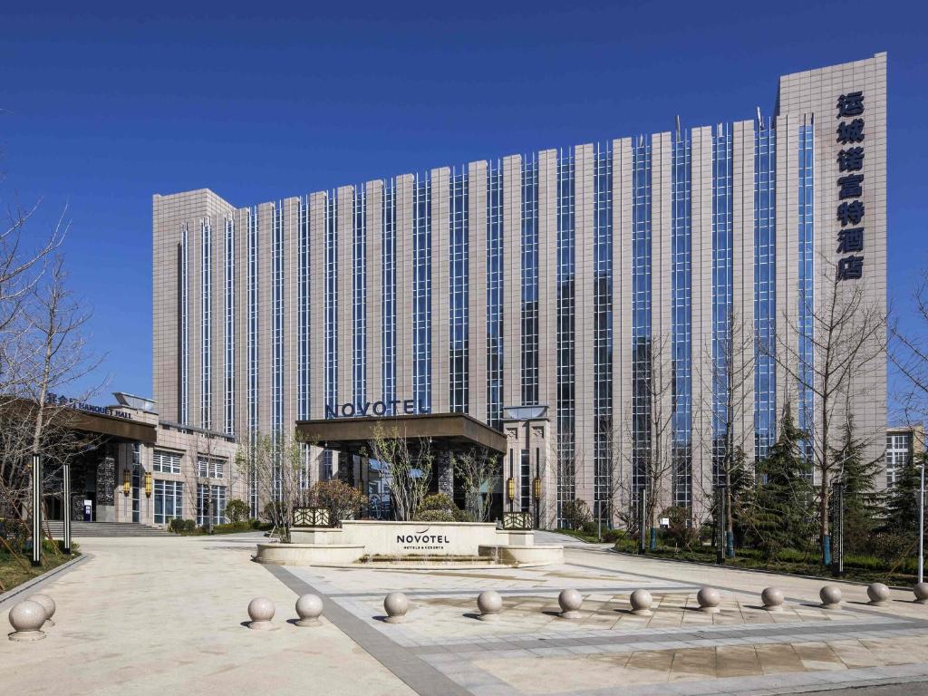 a large building with a plaza in front of it at Novotel Shanxi Yuncheng in Yuncheng