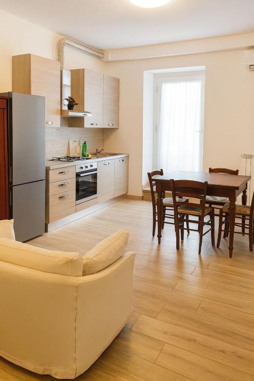a kitchen and dining room with a table and chairs at borgo nel vigneto 2 in Erbusco