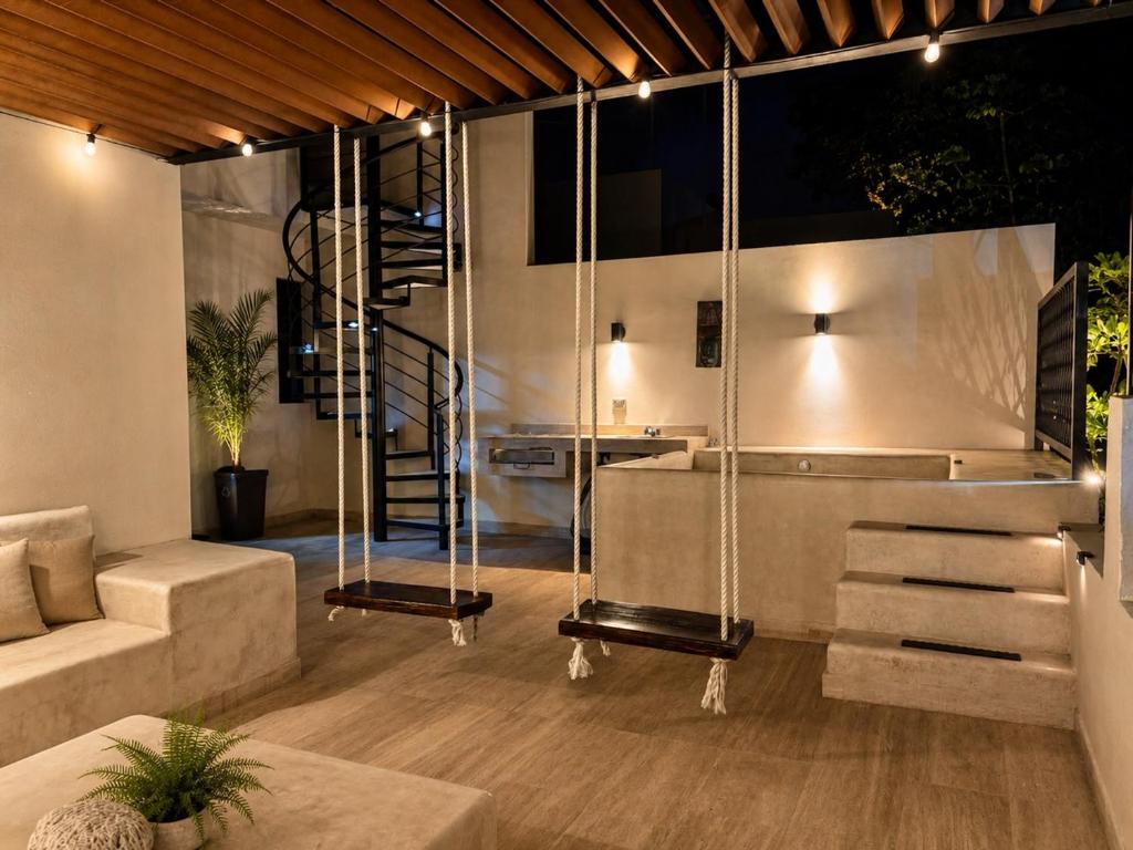a living room with a couch and a staircase at Casa Vibe PH- Private Rooftop - 3 Balcony - Pool in Tulum