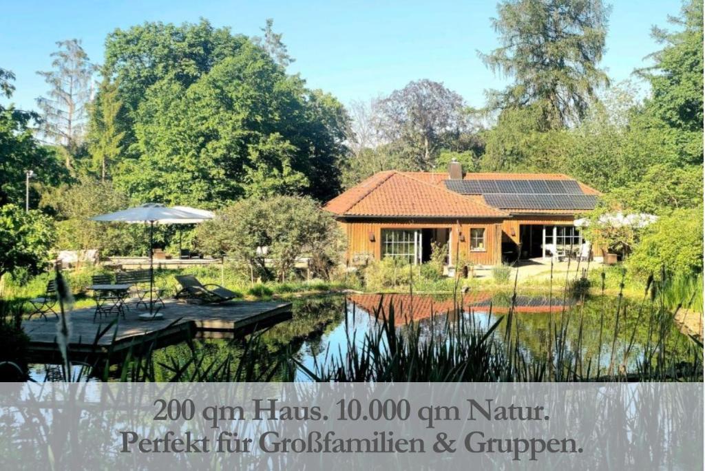 a house by the water with a dock at NaturQuartier am Stadtrand von Nürnberg in Stein