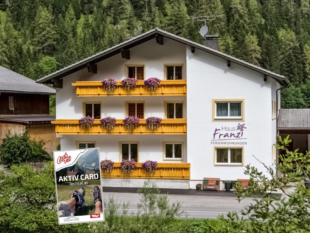 a white building with a sign in front of it at Haus Franzi in Steeg