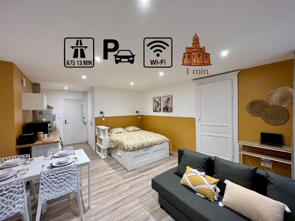 a living room with a couch and a bed at La Palmeraie in Brioude