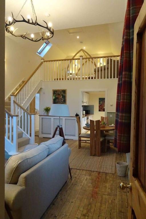a living room with a couch and a table at School Room in Lochgilphead