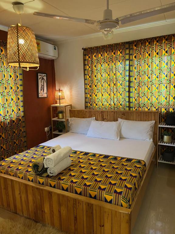 a bedroom with a large bed in a room at African Treasure kokrobite in Kokrobite