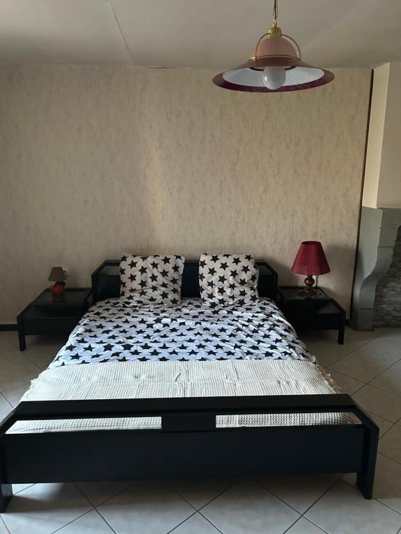 a bed in a room with two tables and a lamp at LEMAFIOlY in Cemboing
