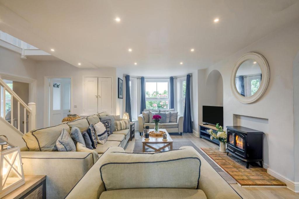 a living room with two couches and a fireplace at 6 Bed in Bacton oc-2316 in Bacton