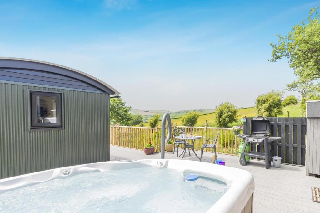 a hot tub on a deck next to a patio at 1 Bed in Knighton oc-51898 in Beguildy