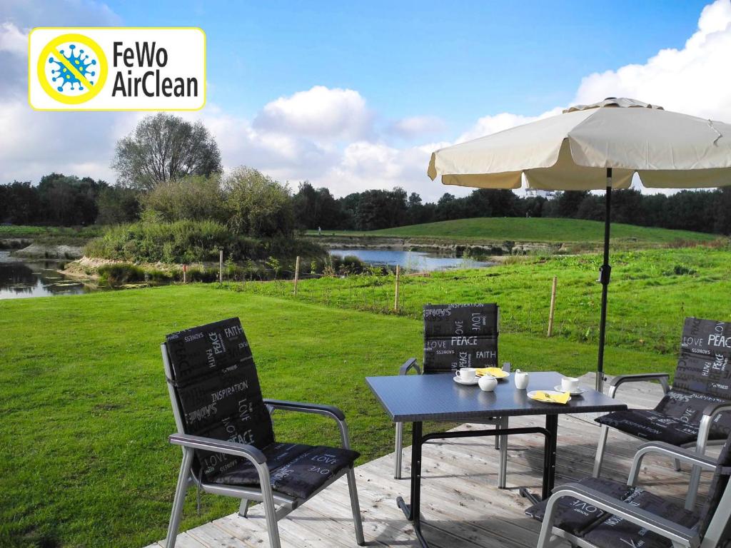 a table and chairs and an umbrella on a patio at Auszeit - Nordhorn in Nordhorn