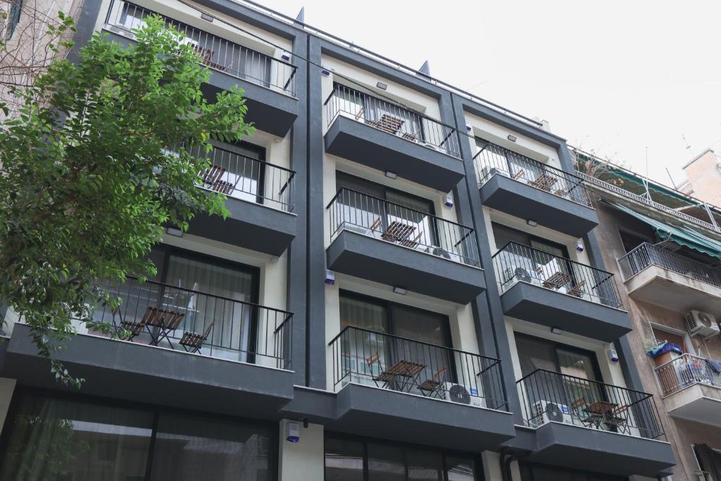 an apartment building with chairs on the balconies at Urban Liv Athens in Athens