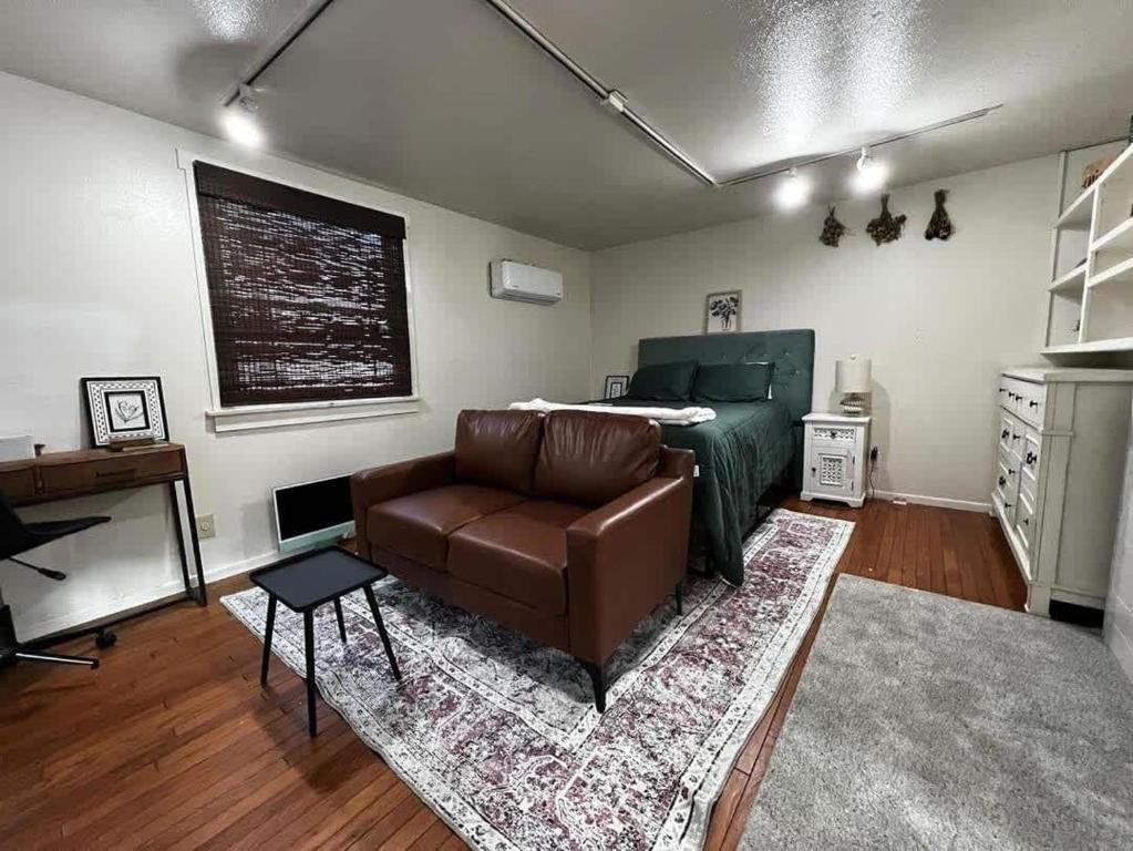 a living room with a couch and a bed at Backyard Bungalow private guest house in Riverside