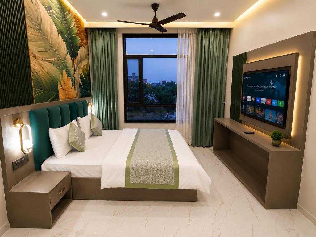 a bedroom with a large bed and a large window at Hotel Heera Palace in Khātu