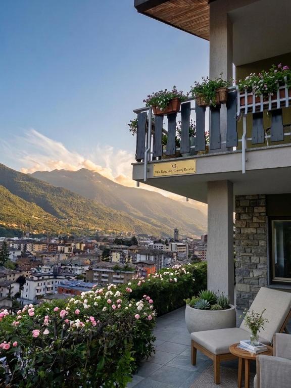 a balcony of a building with a view of a city at Villa Borghino in Sondrio