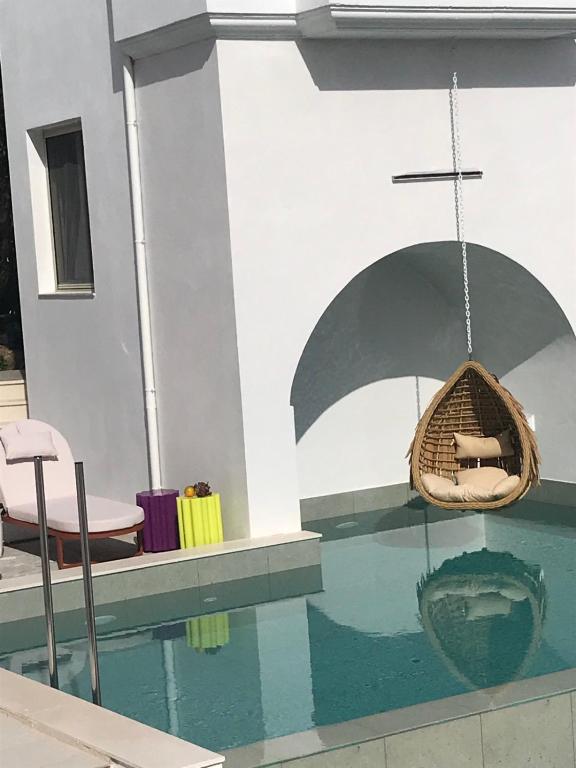 a swimming pool with a swing in a house at Rozmari Suites in Agia Galini