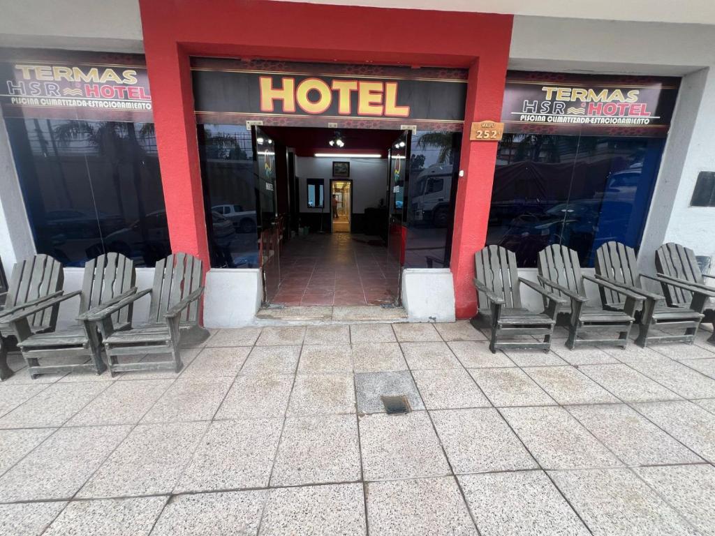a group of chairs sitting outside of a hotel at HSR Termas in Termas de Río Hondo