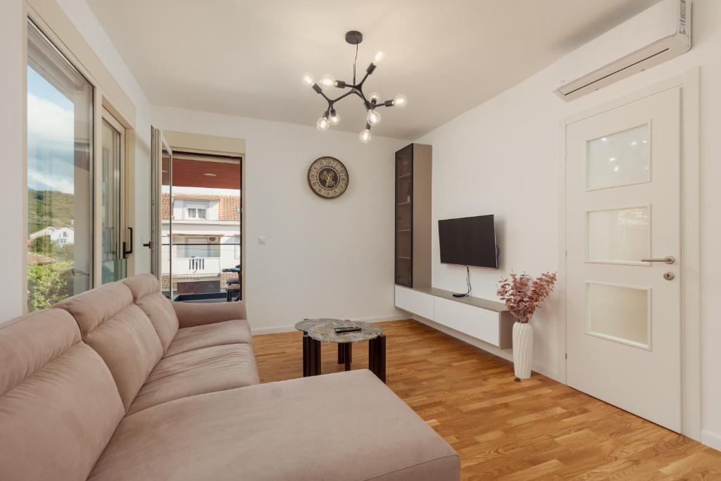 a living room with a couch and a tv at Vujicic Premium Suite in Tivat