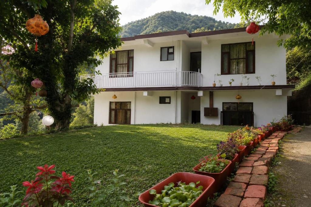 a house with some plants in a yard at The Sanctuary in McLeod Ganj