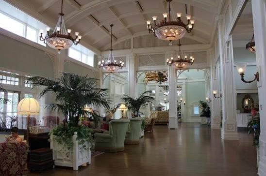 a lobby with chandeliers and palm trees in a building at Kzea's Inn in Kidapawan
