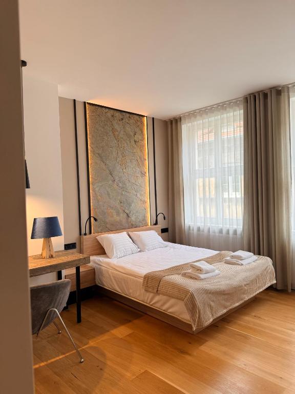 a bedroom with a bed and a desk and a window at Kamea in Poznań