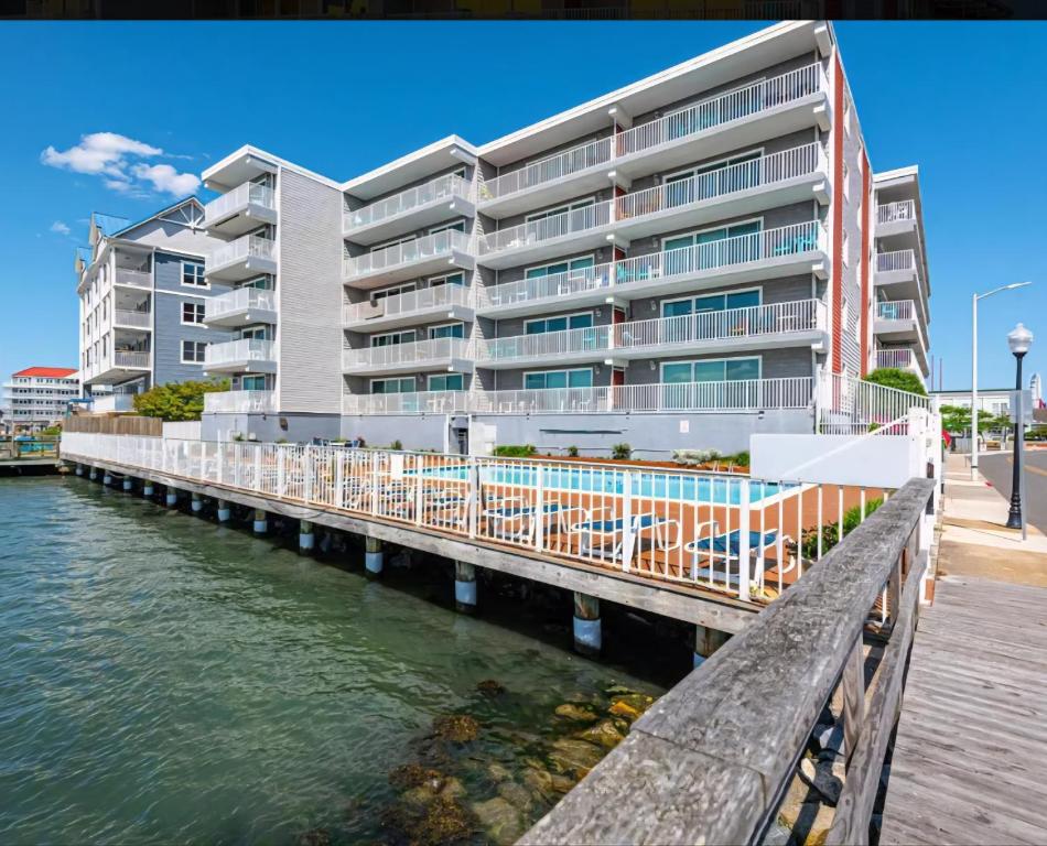 a building on a dock next to a body of water at 210 Worcester St #203 OC in Ocean City