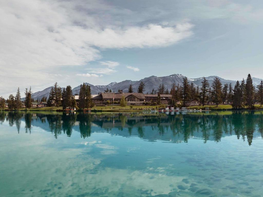 a large body of water with houses and trees at Fairmont Jasper Park Lodge in Jasper