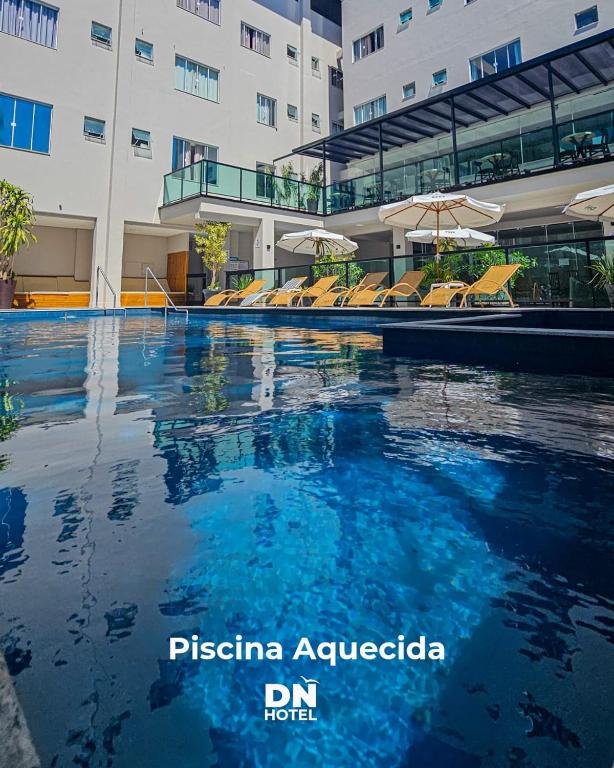 a swimming pool in front of a building at Das Nações Hotel in Florianópolis
