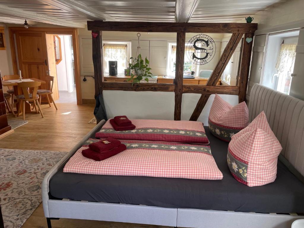 a bed with two pillows on it in a room at FEWO Blockstube Frieda in Kottmar