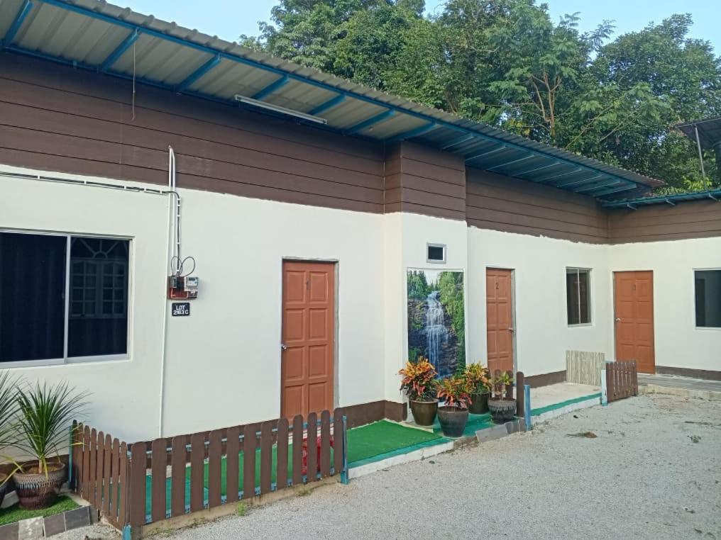 a small house with a fence in front of it at Desa Landak Chalet in Jertih